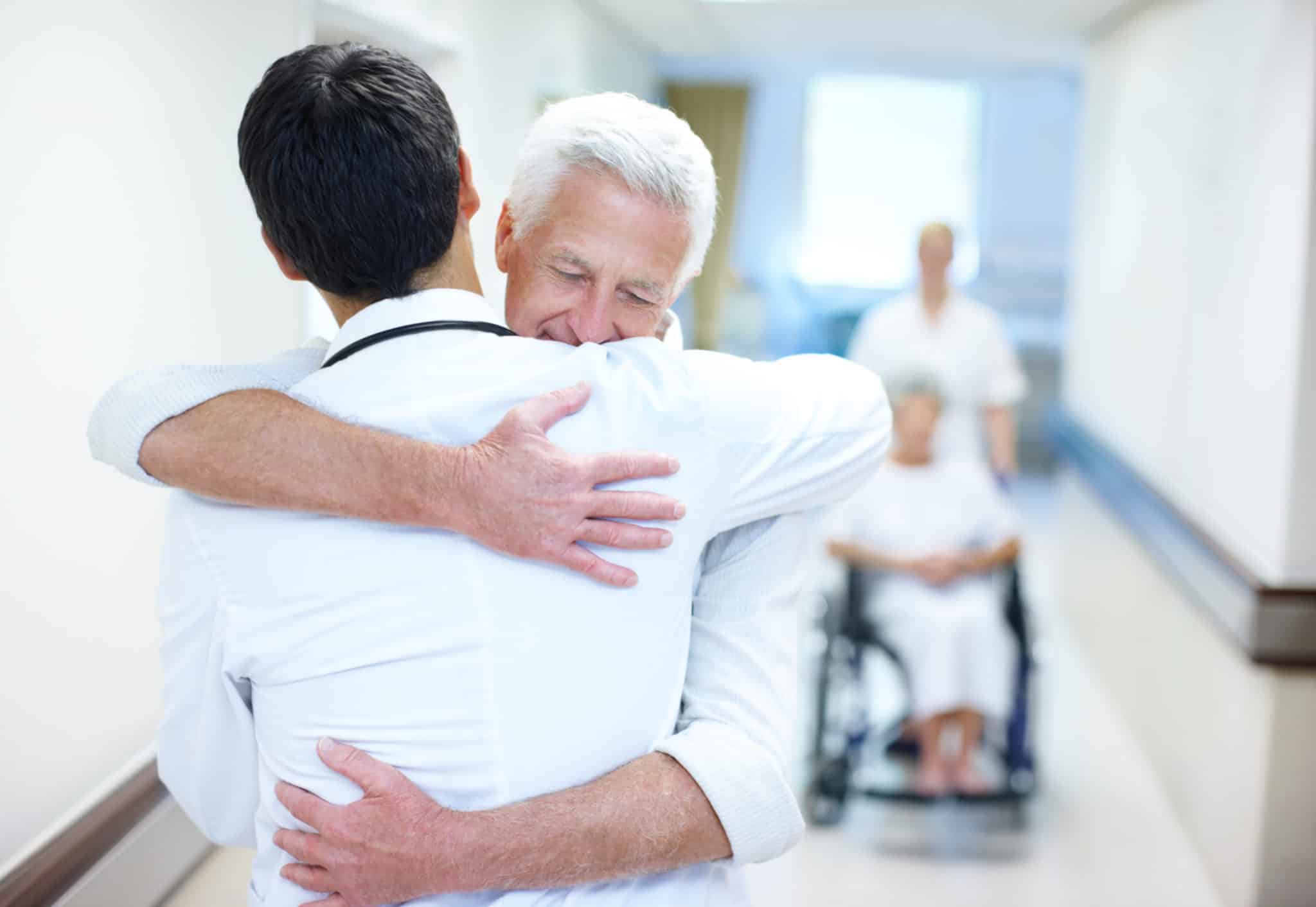 Two men in embracing each other in the hospital hall