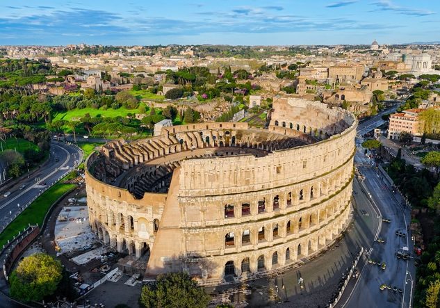 Aerial View Of The Ancient Colosseum In Rome With Panoramic Cityscape Iconic Roman Amphitheater From Different Angles Including Top Down Detail Historical Architecture And Tourism Concept For Editorial And Travel Design